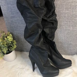 Thigh high boots w/ 4 1/2 inch heel.